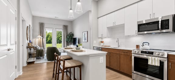 A modern kitchen with a dining table and chairs.