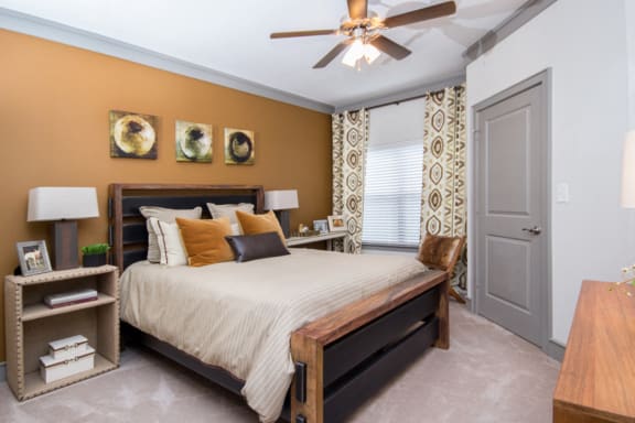 Cozy bed, lamp and ceiling fan at Atria Apartment Homes, Tulsa, Oklahoma