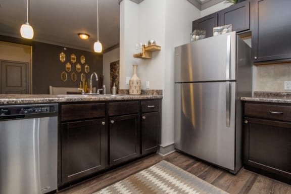 Kitchen with wooden cabinets at Atria Apartment Homes, Tulsa, 74133