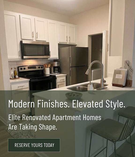 A modern kitchen with a sink, a counter, and a chair.
