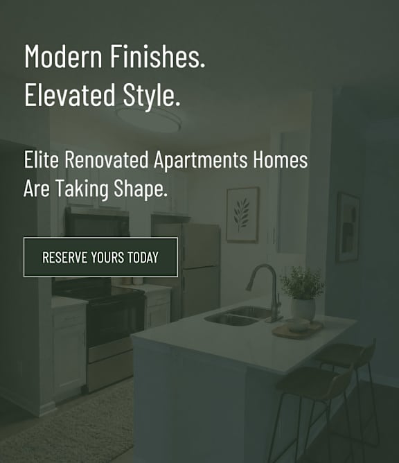 A modern kitchen with a sink, a counter, and a chair.