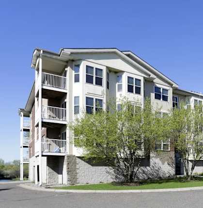 Apartment building with a clear blue sky above.