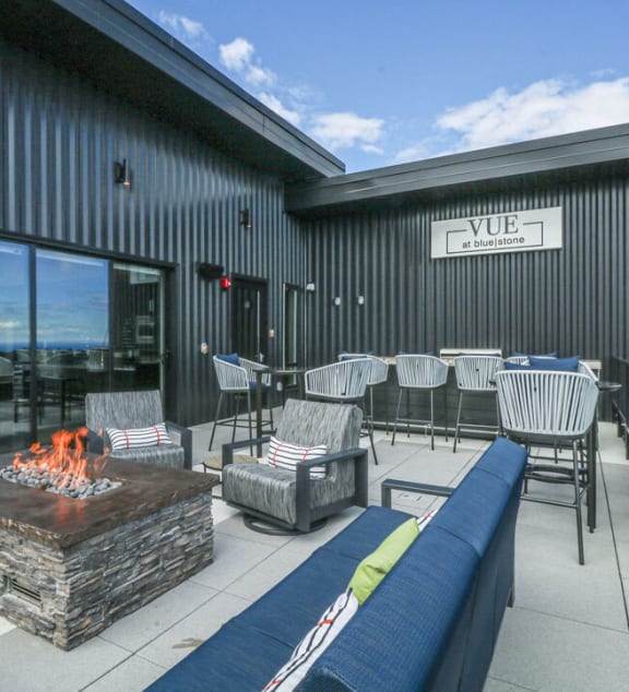 a patio with a fire pit and tables and chairs at Vue at Bluestone, Duluth, Minnesota