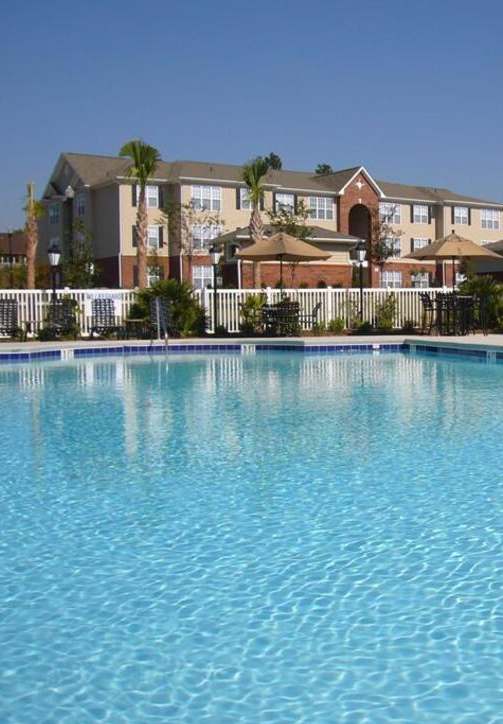 A swimming pool in front of a residential area.