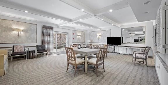A dining room with a table set for six.