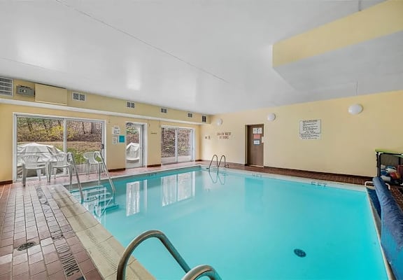 A large indoor swimming pool with a glass divider.
