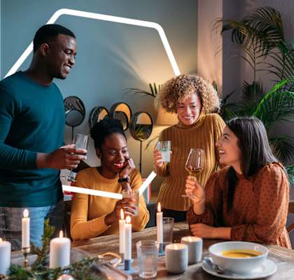 a group of people gathered around a dinner table drinking wine