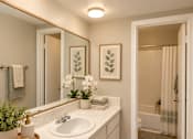 Thumbnail 3 of 11 - A bathroom with a sink, mirror, and shower at Lifestyle at Shreveport in Shreveport, LA, 71109.