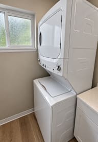 A white washing machine and dryer in a laundry room.