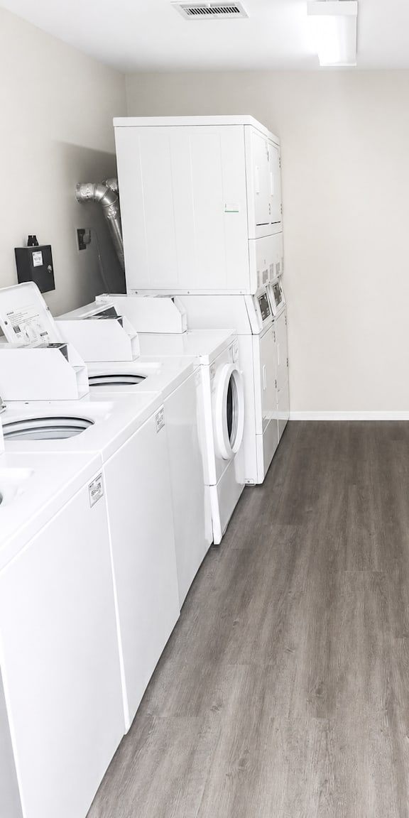 A row of washing machines in a laundromat.