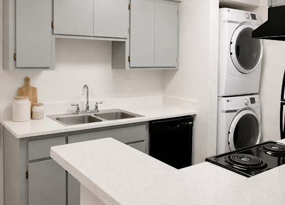 A white kitchen with a black stove top.