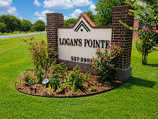 A sign for Logan's Pointe with a phone number on it.