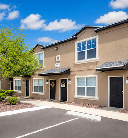 A row of houses with black front doors.