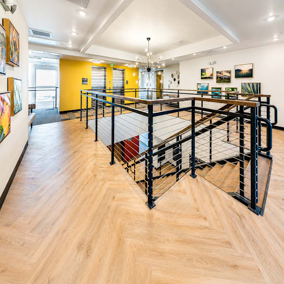 A black metal staircase with a wooden floor.