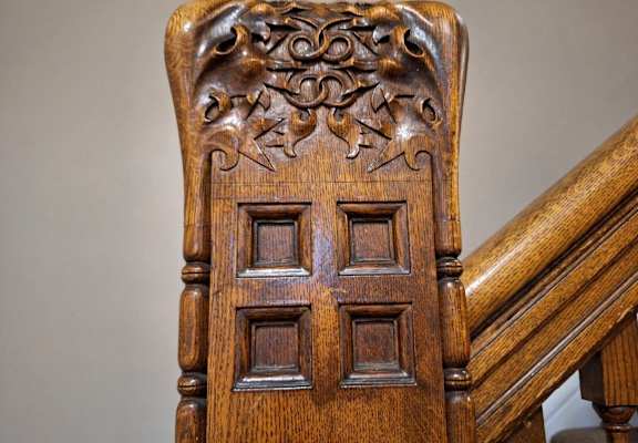 an upholstered chair with a door on a staircase