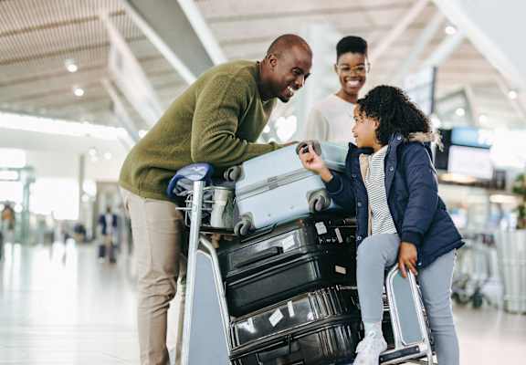 a man and woman with luggage at an airport