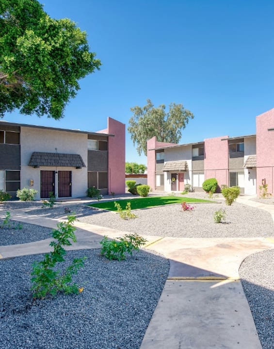 a street view of an apartment complex with trees and landscaping at Connect on Missour Apartments, Phoenix 85015