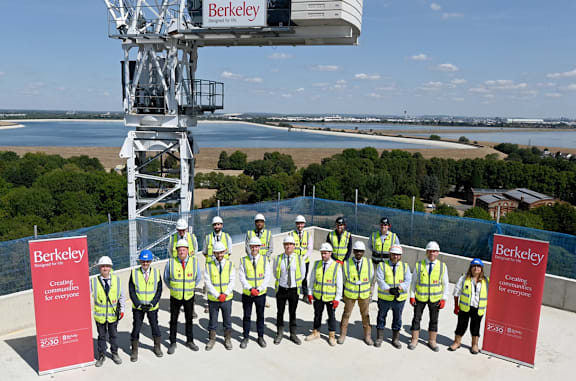 A group of people in safety vests are standing in front of a Berkeley sign.