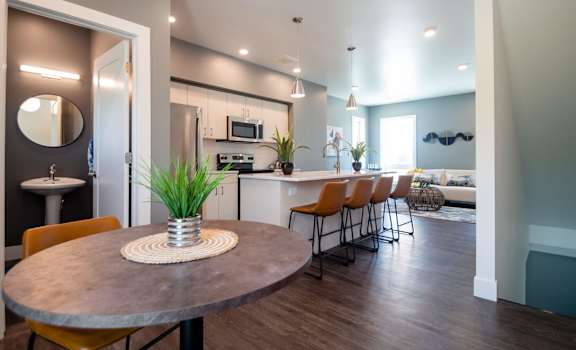 A modern kitchen with a round table and chairs.