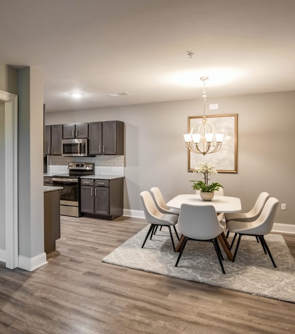 A kitchen with brown cabinets and a wooden floor at Mode at Melbourne, LLC Apartments, Florida