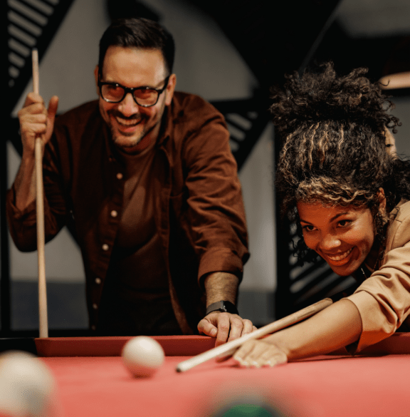 a man and woman playing a game of pool