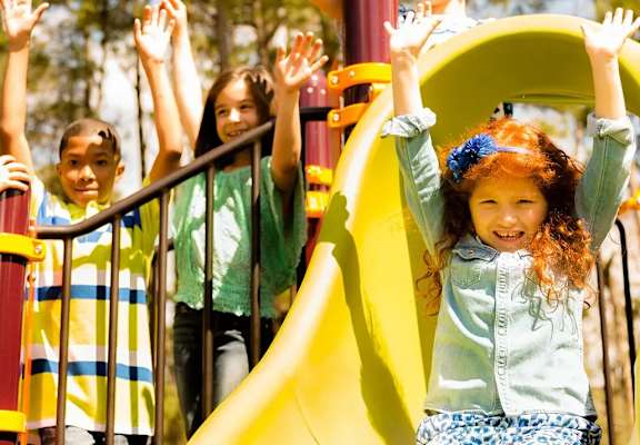 Children playing on a playground slide.