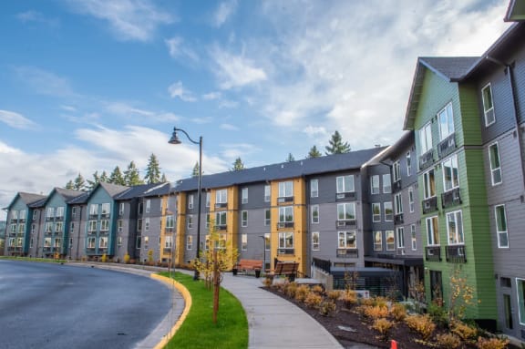 a row of new apartment buildings on the side of a road