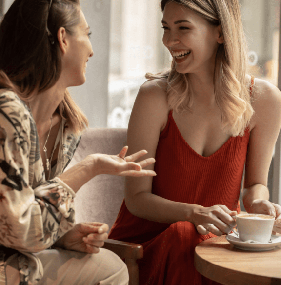 two women chatting over a cup of coffee