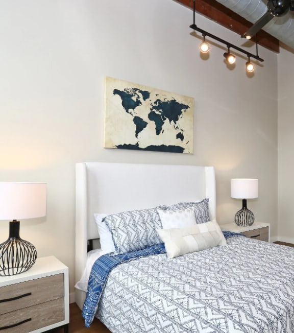 a bedroom with a bed and a ceiling fan