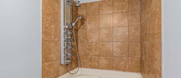 a bathroom with a bathtub and a shower