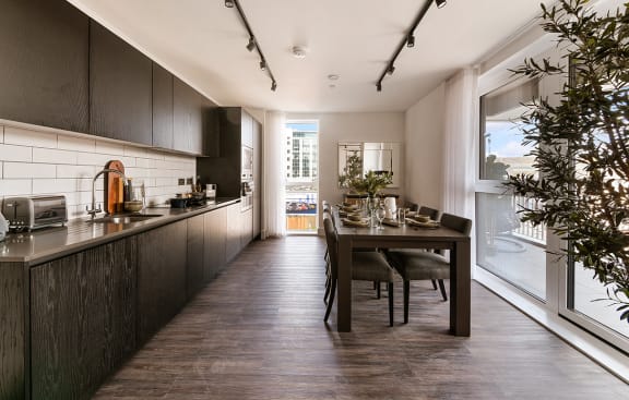 a kitchen with navy blue cabinets and a white counter top