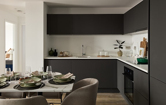 a kitchen with navy blue cabinets and a white counter top