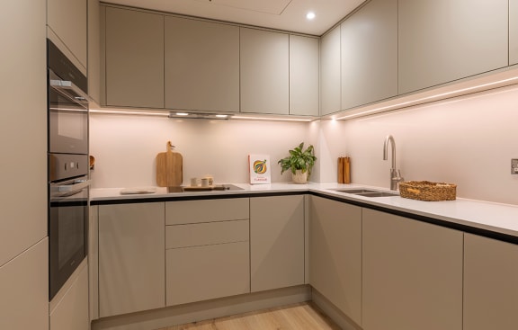a kitchen with navy blue cabinets and a white counter top