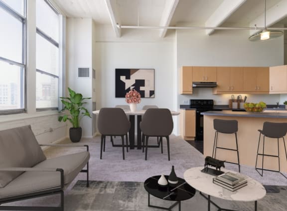 a living room with a kitchen and a dining room with chairs and a table