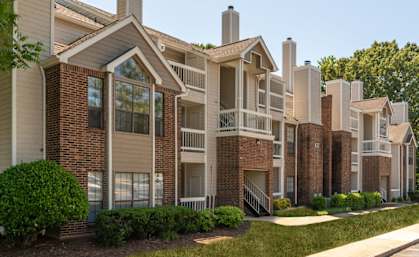Apartment complex with brick and beige buildings.