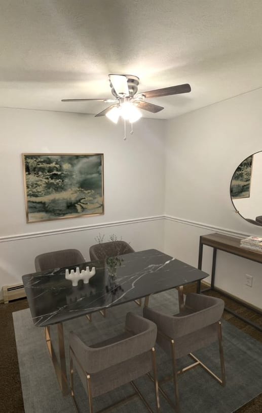 a dining room with a table and chairs and a ceiling fan