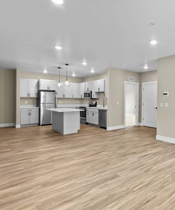 A top-down view of a small apartment with a kitchen, living room, and bedroom.