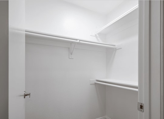 a walk in closet with a white wall and a white door at Huntington Terrace North Senior, Huntington Beach, 92648