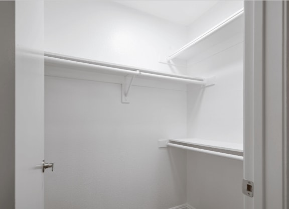 a walk in closet with a white wall and a white door at Huntington Terrace North Senior, Huntington Beach, 92648