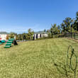 A playground with a blue slide and wooden structure.