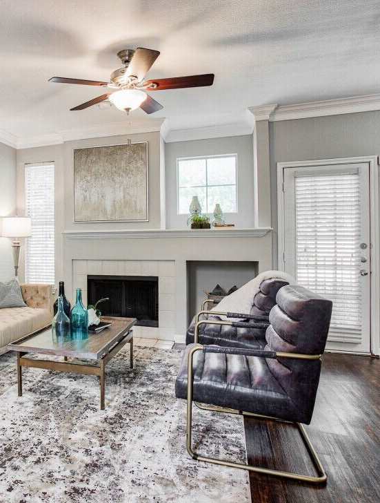 A living room with a fireplace and a chair.