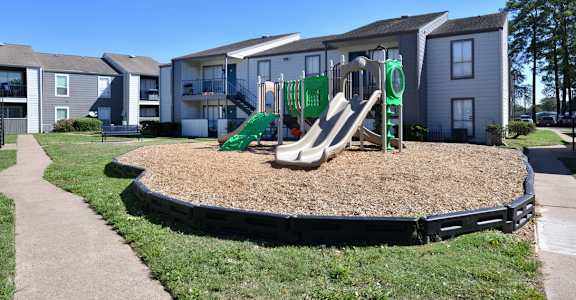 Playground with beige slide at Normandy Woods in Riviera East, Houston, TX, 77015