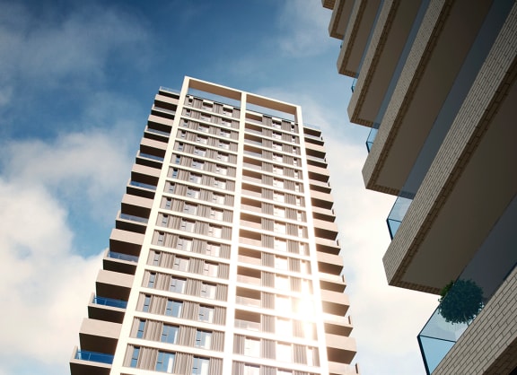 a view of two brick apartment buildings against a blue sky