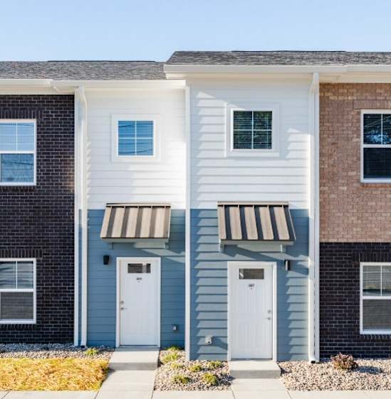 A row of townhouses with different colored exteriors.