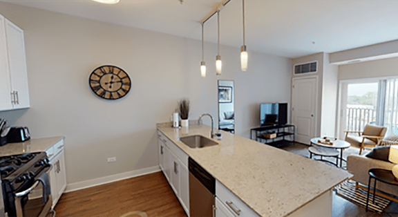 A kitchen with a large island and a clock on the wall.