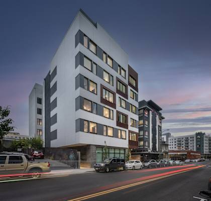 a rendering of a white building on a city street