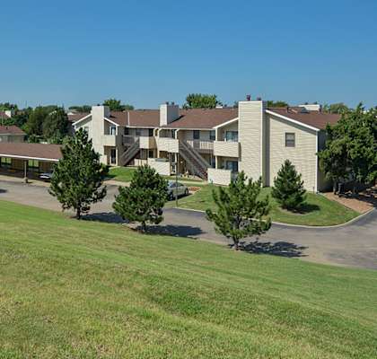 an aerial view of an apartment complex with grass and trees