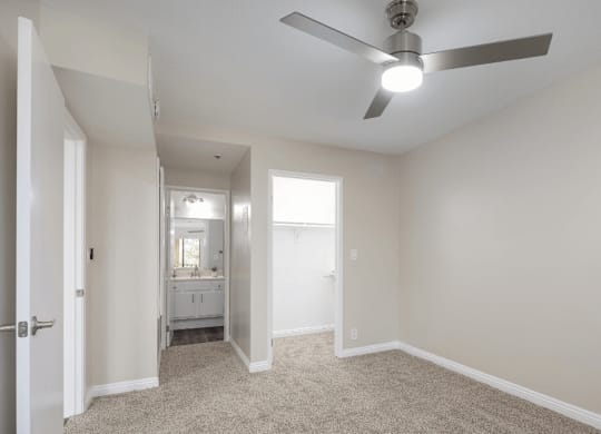 an empty living room with a ceiling fan at Huntington Terrace North Senior, California, 92648