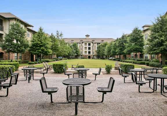 an empty patio at an event with tables and chairs