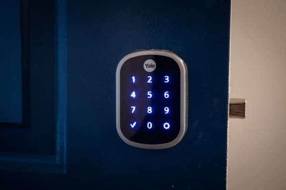 a blue door lock with a lit up clock on it